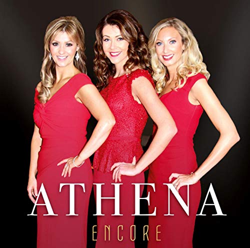 Three women in red dresses stand together, smiling, on a black background.