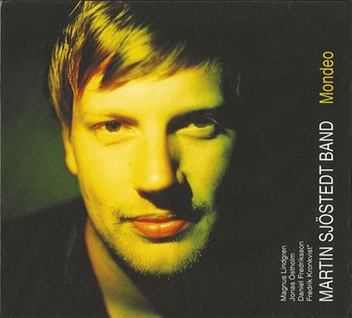 "CD cover with a man's face, lit with yellow light, on a dark background."