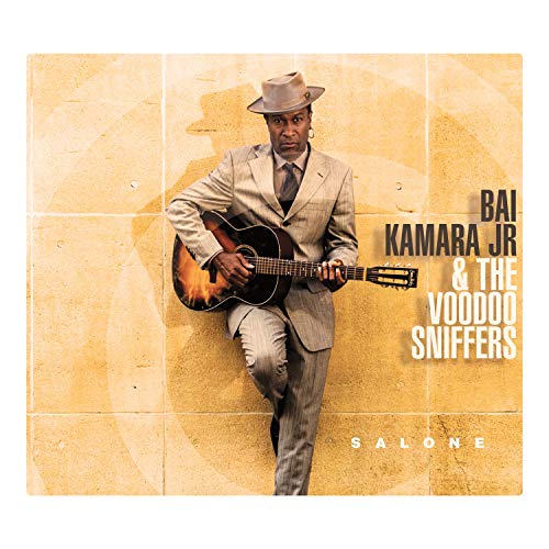Album cover featuring a man in a suit holding a guitar against a tiled wall.
