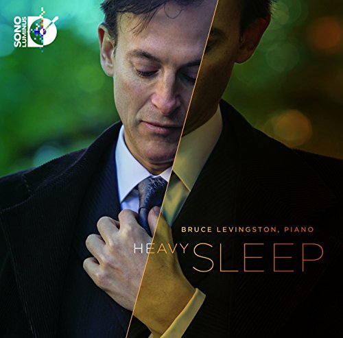 "Album cover with a man in a suit and tie, text 'Heavy Sleep'."