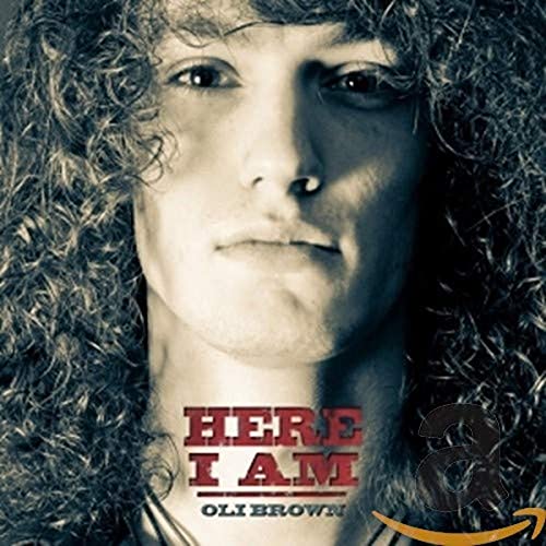 Close-up portrait of Oli Brown with album title "Here I Am.