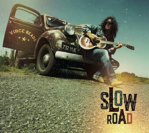 "Album cover featuring a man with a guitar sitting by a vintage truck."