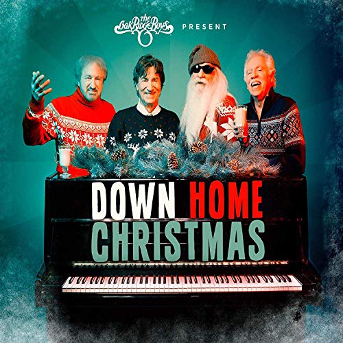 "Album cover featuring four men behind a piano with festive decorations and text."