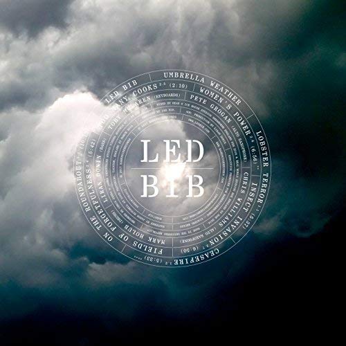 "Cloudy sky with a circular graphic containing 'LED Bib' and song titles."
