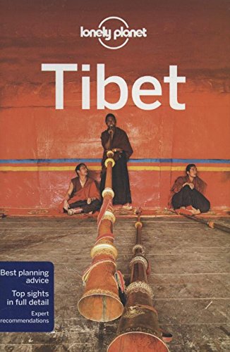 "Lonely Planet Tibet travel guide cover featuring monks playing drums against a red background."