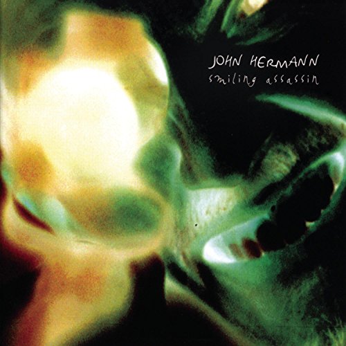 Album cover with a close-up skull image and "John Hermann smiling assassin" text.