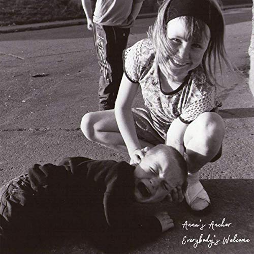 "Black and white vinyl record cover featuring a girl crouching over a lying child."