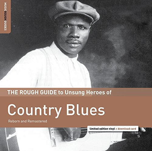 "Black and white album cover featuring a man holding a guitar, wearing a cap."