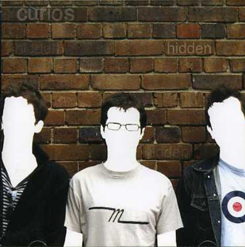 Album cover with three faceless men standing in front of a brick wall.