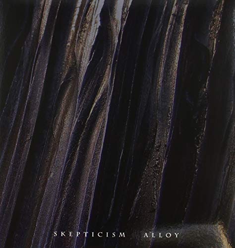 The image depicts a dark, textured surface with the text "SKEPTICISM ALLOY" at the bottom. For accessibility purposes, a suitable alt text could be: "Dark, crinkled metal surface with 'Skepticism Alloy' text at the bottom."