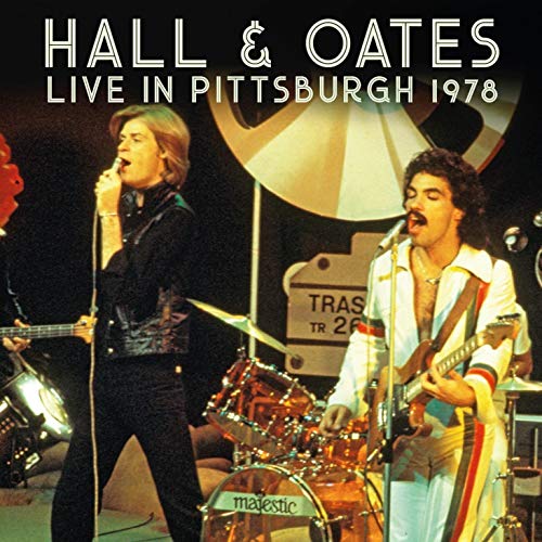 Hall & Oates album cover featuring two men performing on stage with musical instruments.
