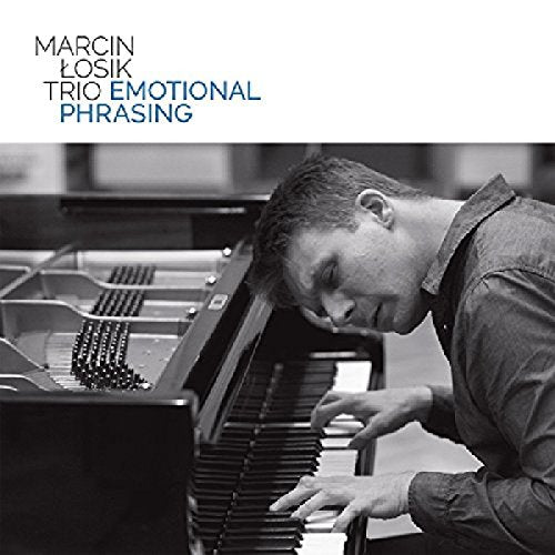 "Man playing piano intensely, black and white image, with album title and artist name."