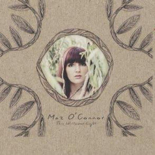 "Album cover with a woman's portrait surrounded by leaves on a beige background."