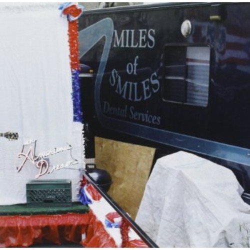The image shows a black vehicle with "MILES of SMILES Dental Services" written on it. For accessibility purposes, a concise, descriptive alt text could be: "Black vehicle with 'MILES of SMILES Dental Services' text."
