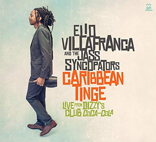 Album cover with man in suit and dreadlocks holding trumpet case, multicolored text.