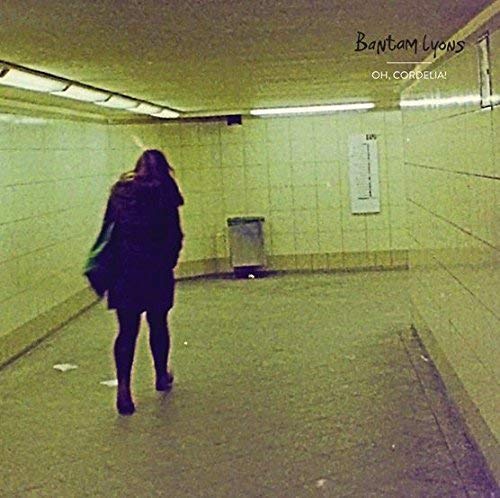 Vinyl record cover featuring a woman walking down a dimly lit corridor.