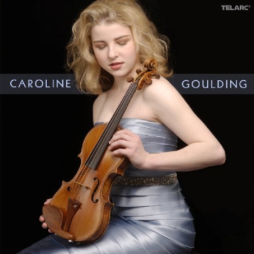 A woman in a silver dress holding a violin against a black background.