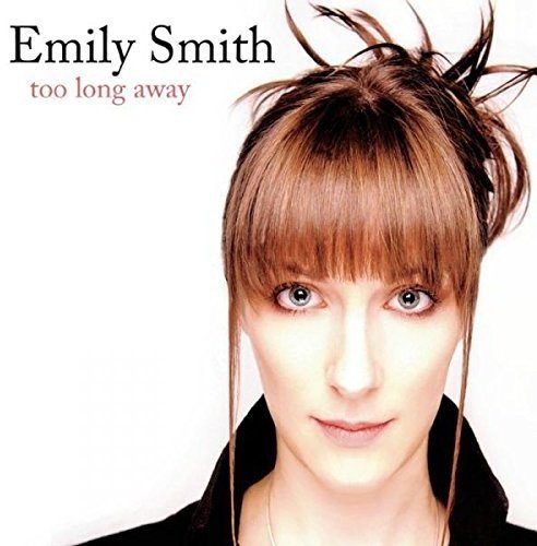 "Album cover featuring a woman with brown hair and bangs against a white background."