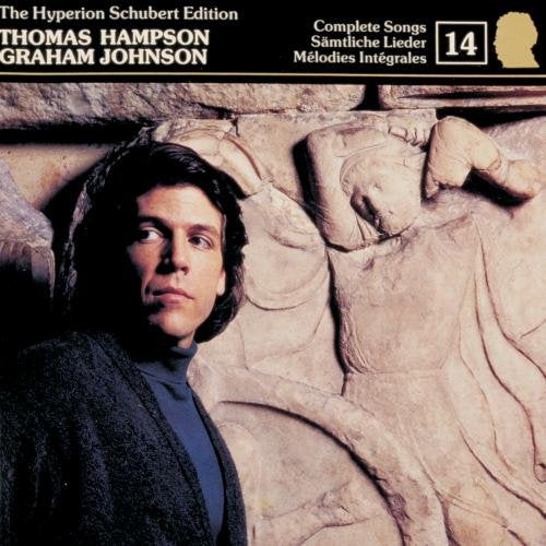 "CD cover with a man and ancient stone carving, featuring white text and a gold silhouette."