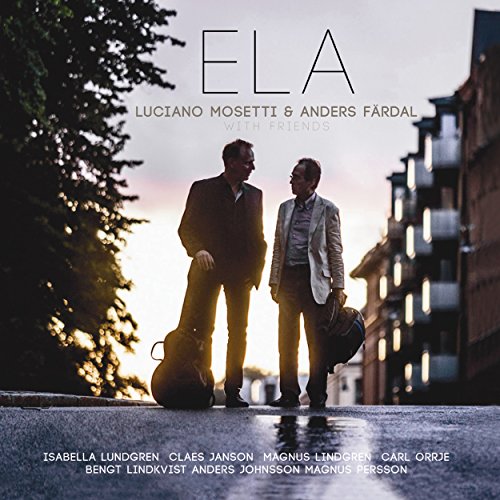 "Album cover with two men holding instrument cases on a city street at sunset."