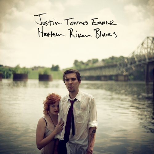 Album cover with a man and woman standing by a river.