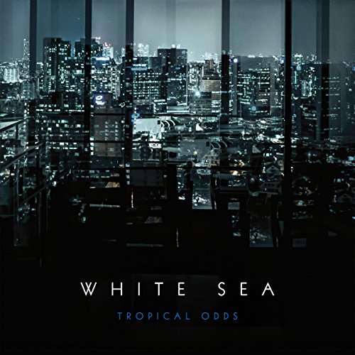 "Album cover with cityscape at night, 'White Sea' and 'Tropical Odds' text."