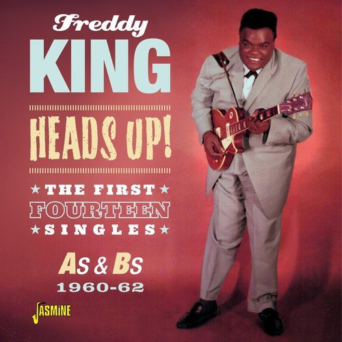 Freddy King album cover featuring a man in a suit playing guitar against a red background.