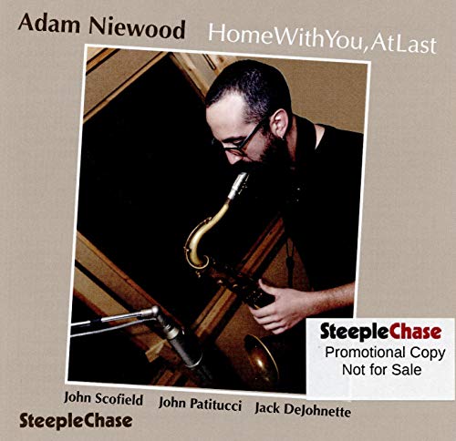 "Album cover featuring a man playing saxophone, with beige background and artist names listed."