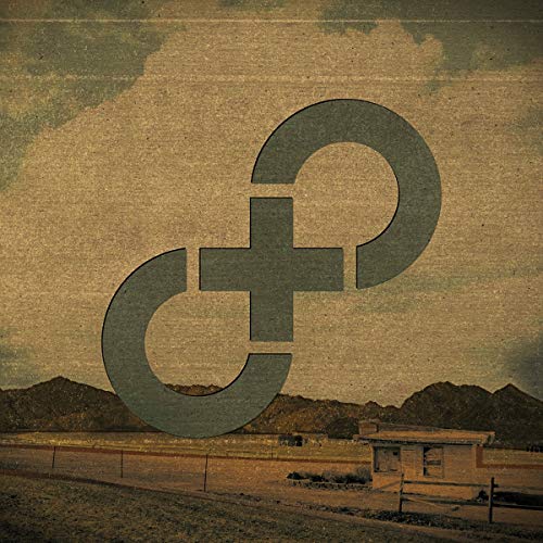 "Vinyl record cover with a sepia-toned landscape and a large, dark symbol overlay."