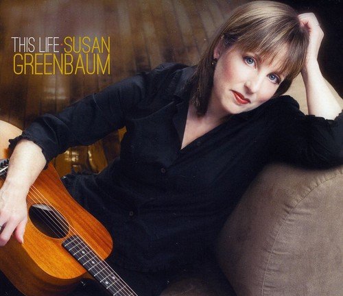 Album cover of Susan Greenbaum holding a guitar, wearing a black shirt, on a couch.