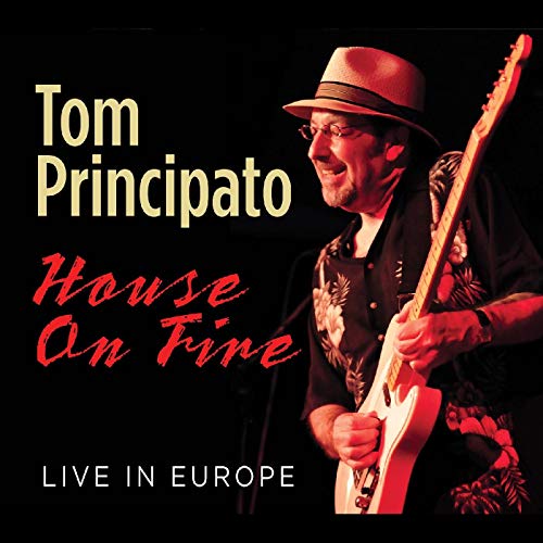 "Album cover featuring Tom Principato playing guitar, wearing a hat, against a black background."
