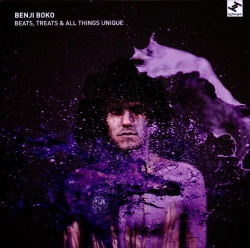Album cover with a man splattered with purple paint against a dark background.