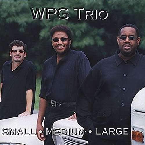 "CD cover featuring three men in black shirts standing by a white car."