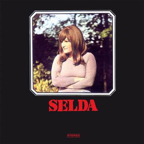 "CD cover with a woman in a pink sweater and the name 'Selda' in red."