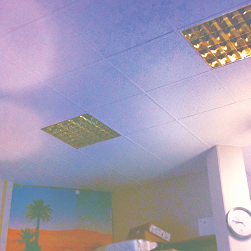 The image appears to be an album cover for "Glass Vaults - The New Happy". A suitable alt text could be: "Ceiling with square glass block skylights and a desert-themed poster."