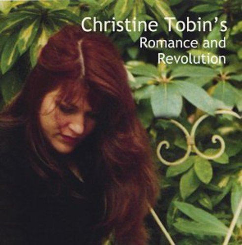 "Album cover featuring a woman with long red hair surrounded by green foliage."