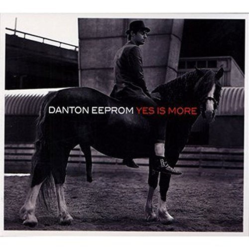 "Album cover featuring a man in a suit riding a horse, with text overlay."