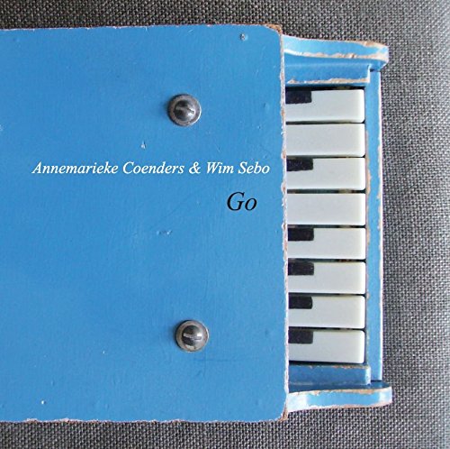 A blue piano keyboard CD cover with the title "Go" on a grey background.