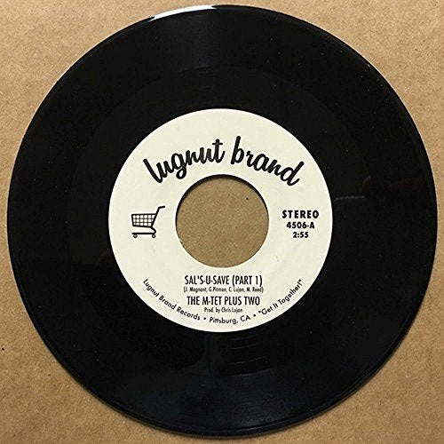 Black vinyl record with white label on a brown background.