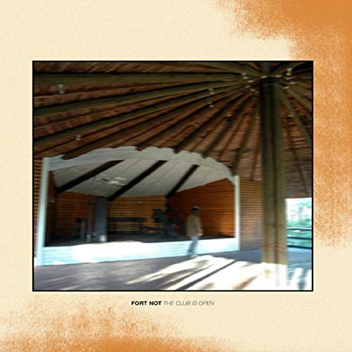 The image depicts a vinyl record cover featuring a photograph of a wooden structure. Alt text: Vinyl record cover with a blurry image of a wooden pavilion.