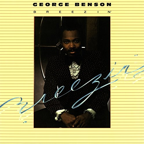 "Album cover featuring George Benson, a man in a dark jacket, on yellow background."
