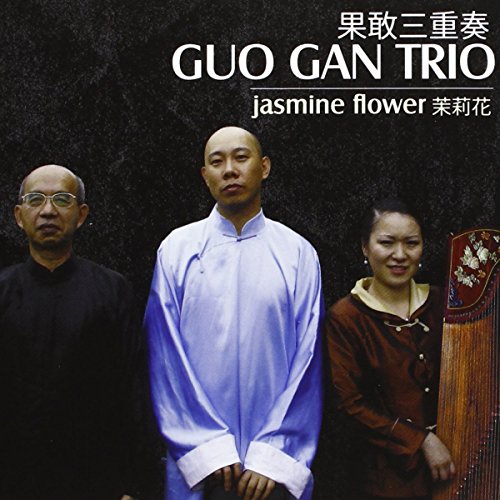 "CD cover featuring three musicians standing together against a dark background."