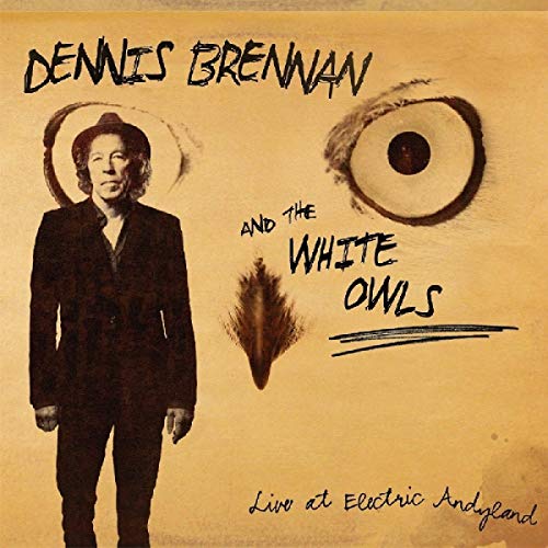 "CD cover with man in suit and owl eye, yellow background."