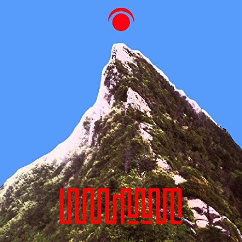 "Mountain peak with red logo and foreign text against a clear blue sky."