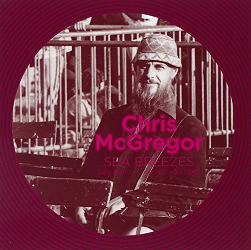 A red-toned album cover featuring a man sitting at a piano.