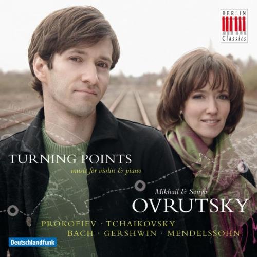 "CD cover featuring a man and woman standing on train tracks."