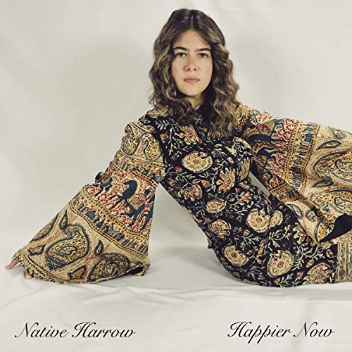 "Woman in patterned dress sitting on white fabric, album cover art for 'Native Harrow - Happier Now'."