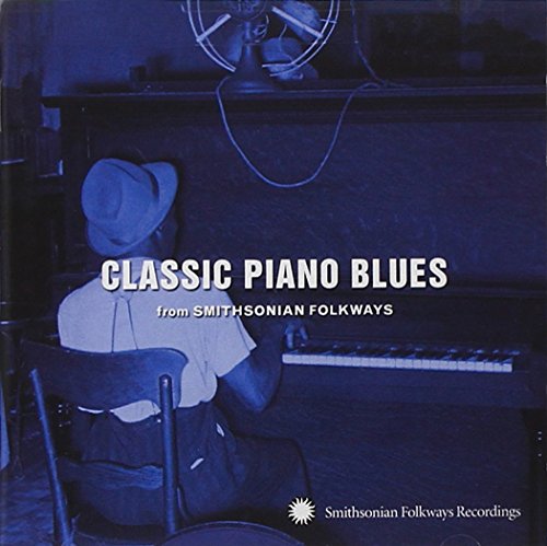 "CD cover with a man playing piano, blue-toned image, white text."