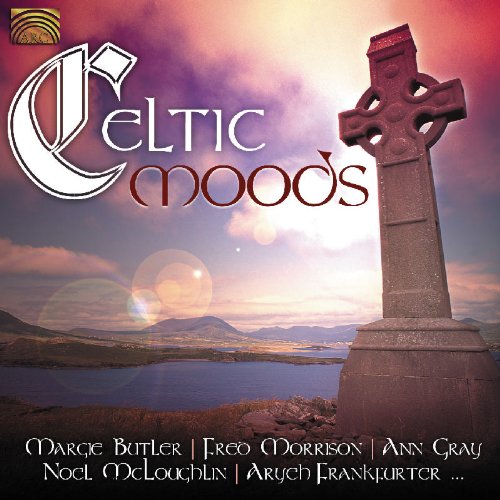 Celtic cross monument beside a lake with cloudy sky and artist names listed below.