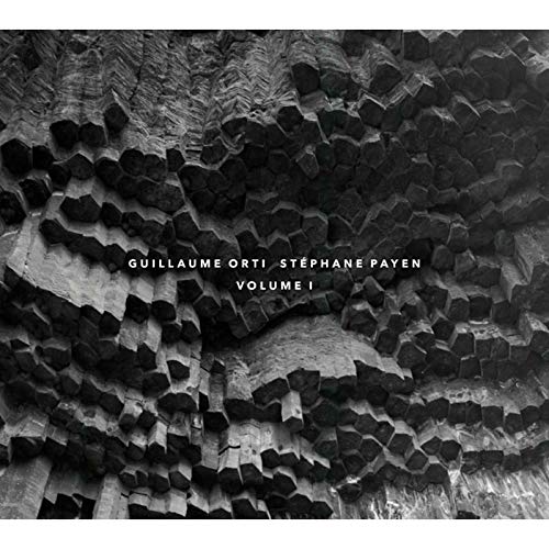 A black and white album cover with abstract, 3D cube-like structures and artist names.